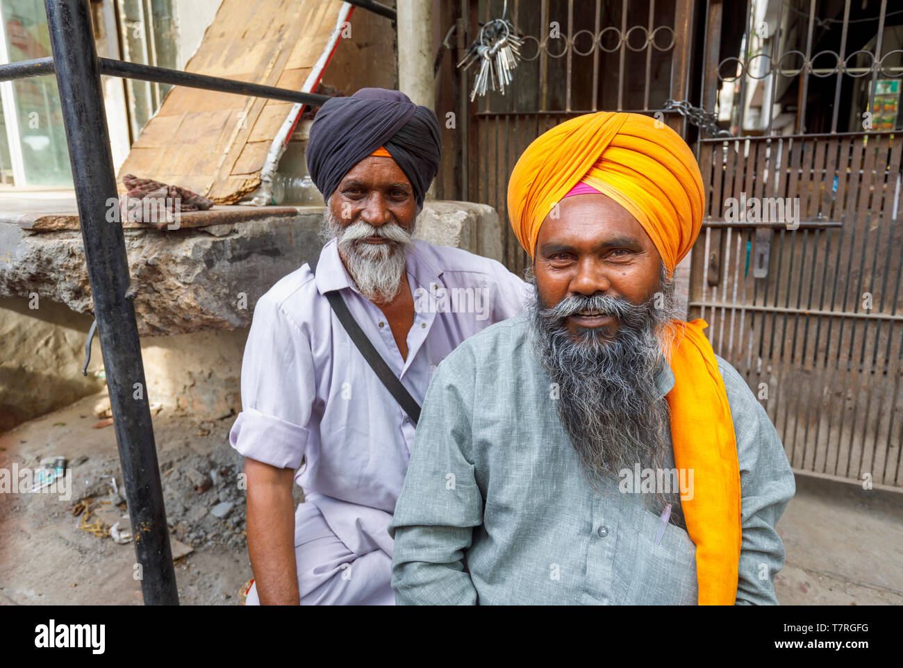 Street scene in Mahipalpur district, a suburb near Delhi Airport in New Delhi, capital city of India: two local men, sikhs in turbans Stock Photo