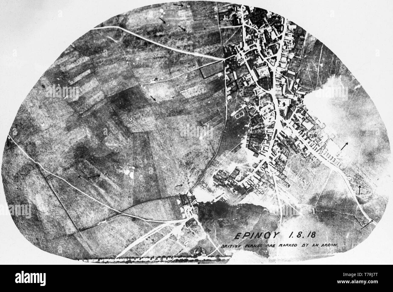 A contemporary British black and white aerial photograph showing  bombing of the town of Epinoy in Northern France on 1st August 1918. A number of British aircraft have been marked with arrows on the photograph. Stock Photo