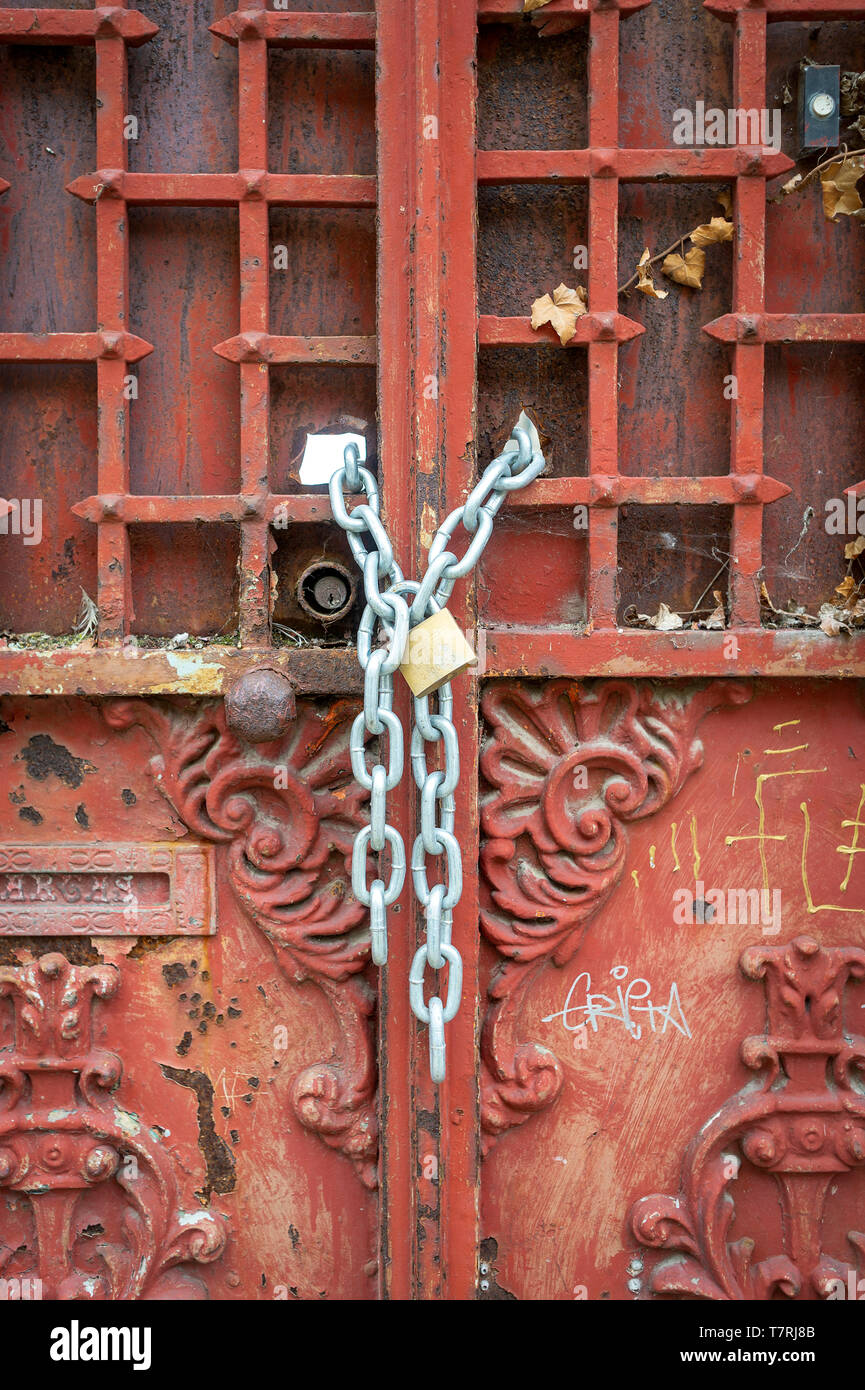 ornate, old metal doors chained and padlocked closed Stock Photo