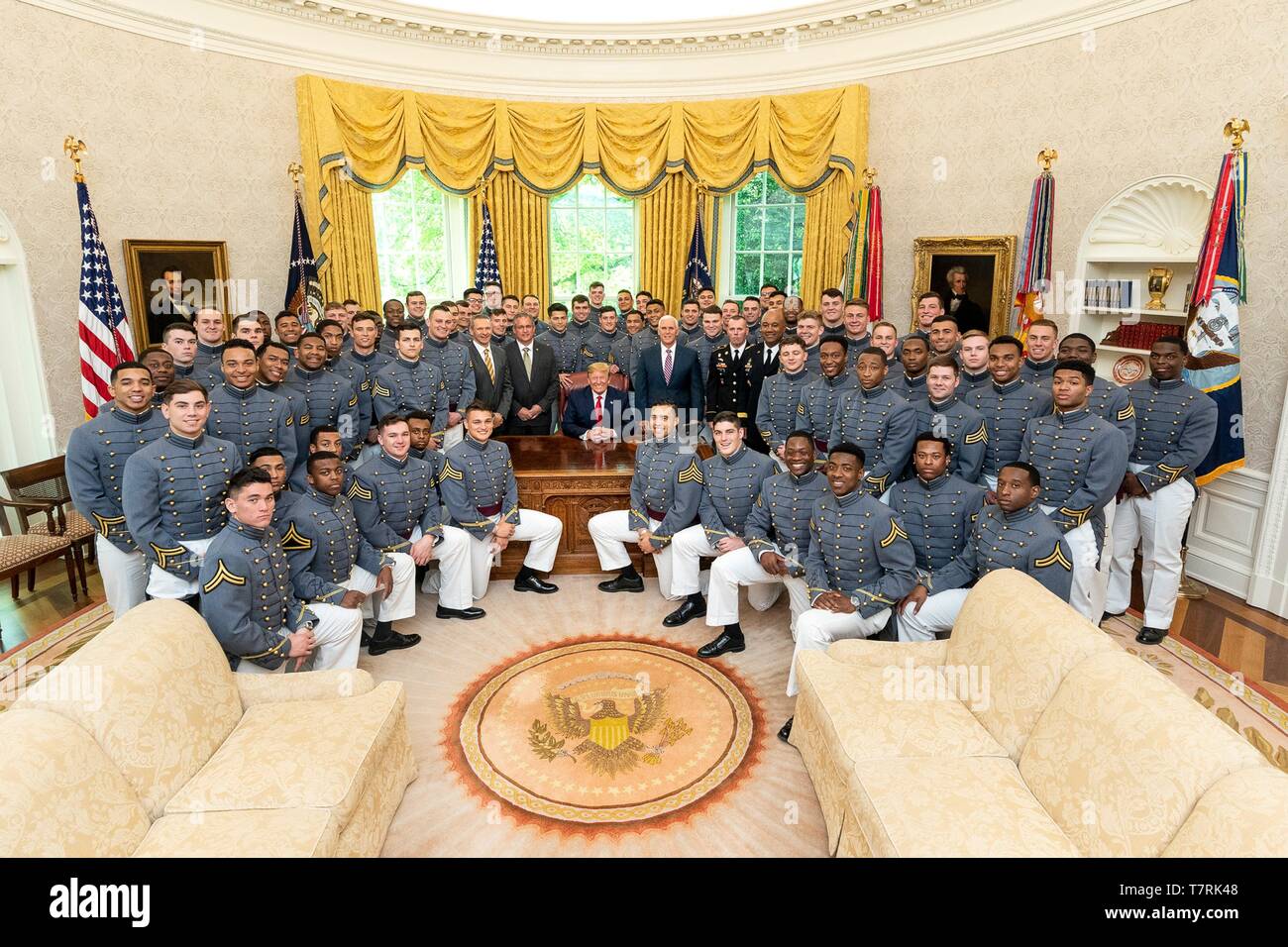 U.S President Donald Trump and Vice President Mike Pence poses for photos with members of the Army Black Knights, the U.S. Military Academy football team in the Oval Office in the White House May 6, 2019 in Washington, DC. Stock Photo