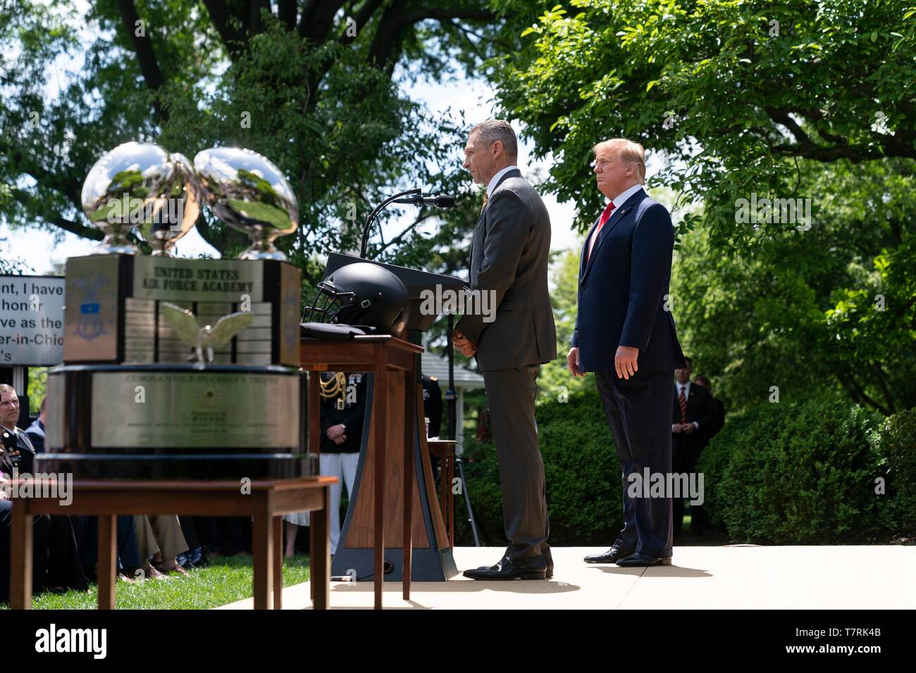U.S President Donald Trump listens as football coach Jeff Monken delivers remarks during the Commander in Chiefs trophy presentation at the Rose Garden of the White House May 6, 2019 in Washington, DC. The Army Black Knights of the U.S. Military Academy football team are the 2018 champions. Stock Photo
