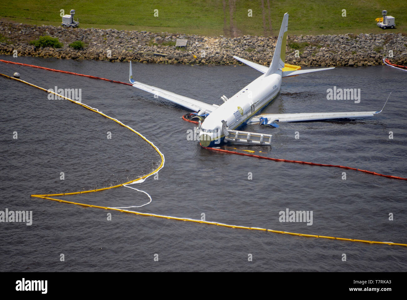A Boeing 737 aircraft rests in shallow water in the St. Johns River at Naval Air Station Jacksonville May 4, 2019 in Jacksonville, Florida. The charter aircraft was transporting 143 military passengers  from Naval Station Guantanamo Bay, Cuba to Jacksonville when it slid off the runway on May 3rd. All passengers survived the crash. Stock Photo