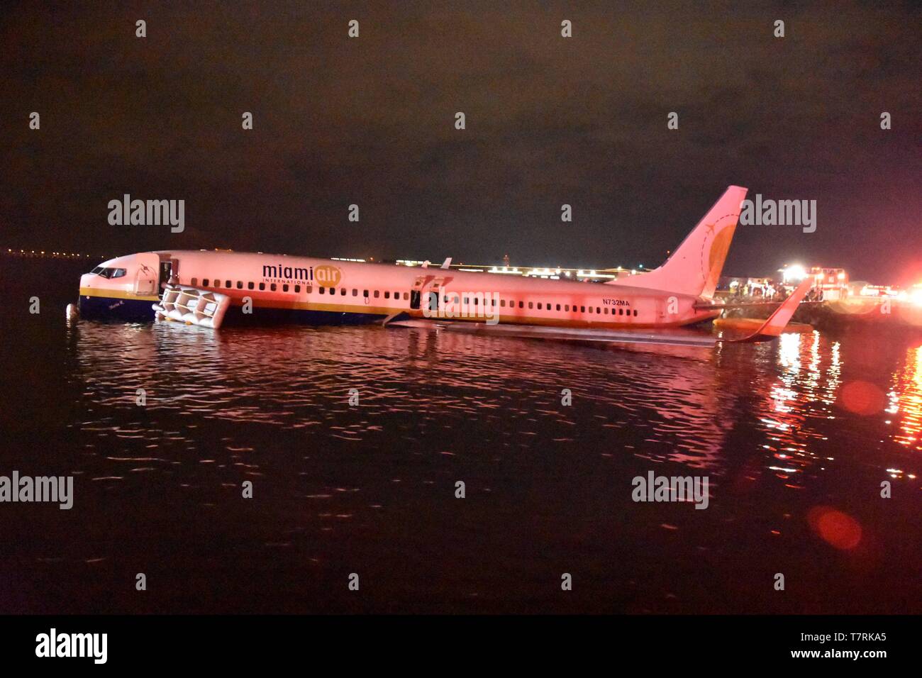 A Boeing 737 aircraft rests in shallow water in the St. Johns River after sliding off the runway at Naval Air Station Jacksonville May 3, 2019 in Jacksonville, Florida. The charter aircraft was transporting 143 military passengers  from Naval Station Guantanamo Bay, Cuba to Jacksonville. All passengers survived the crash. Stock Photo