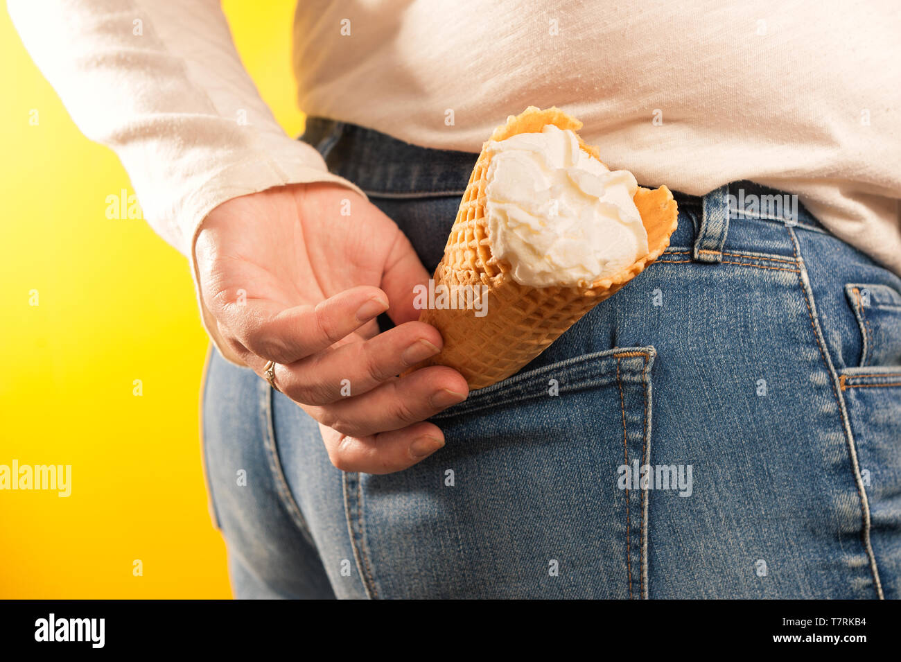 ice cream cone in jeans pocket on yellow background Stock Photo - Alamy