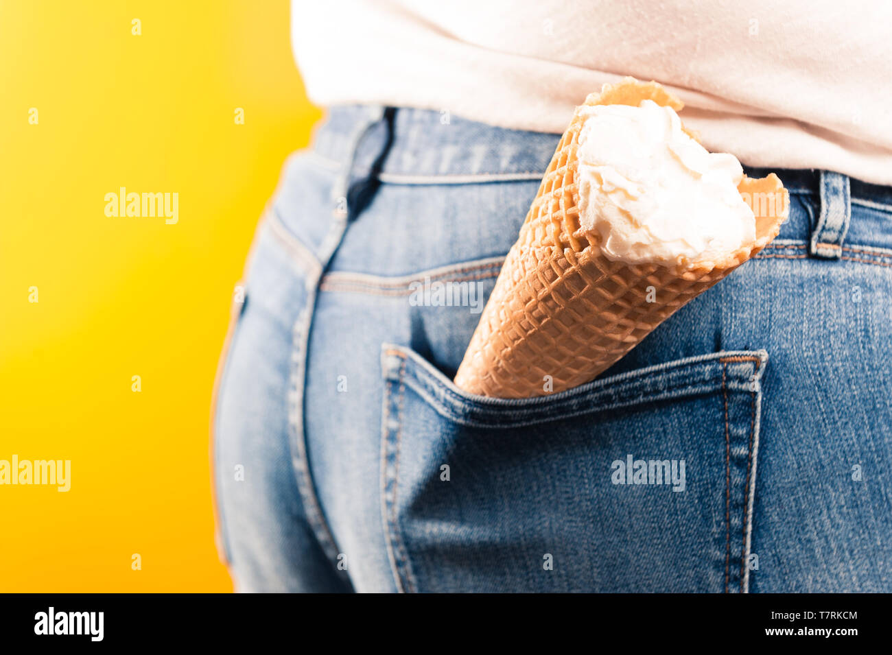 ice cream cone in jeans pocket on yellow background Stock Photo - Alamy