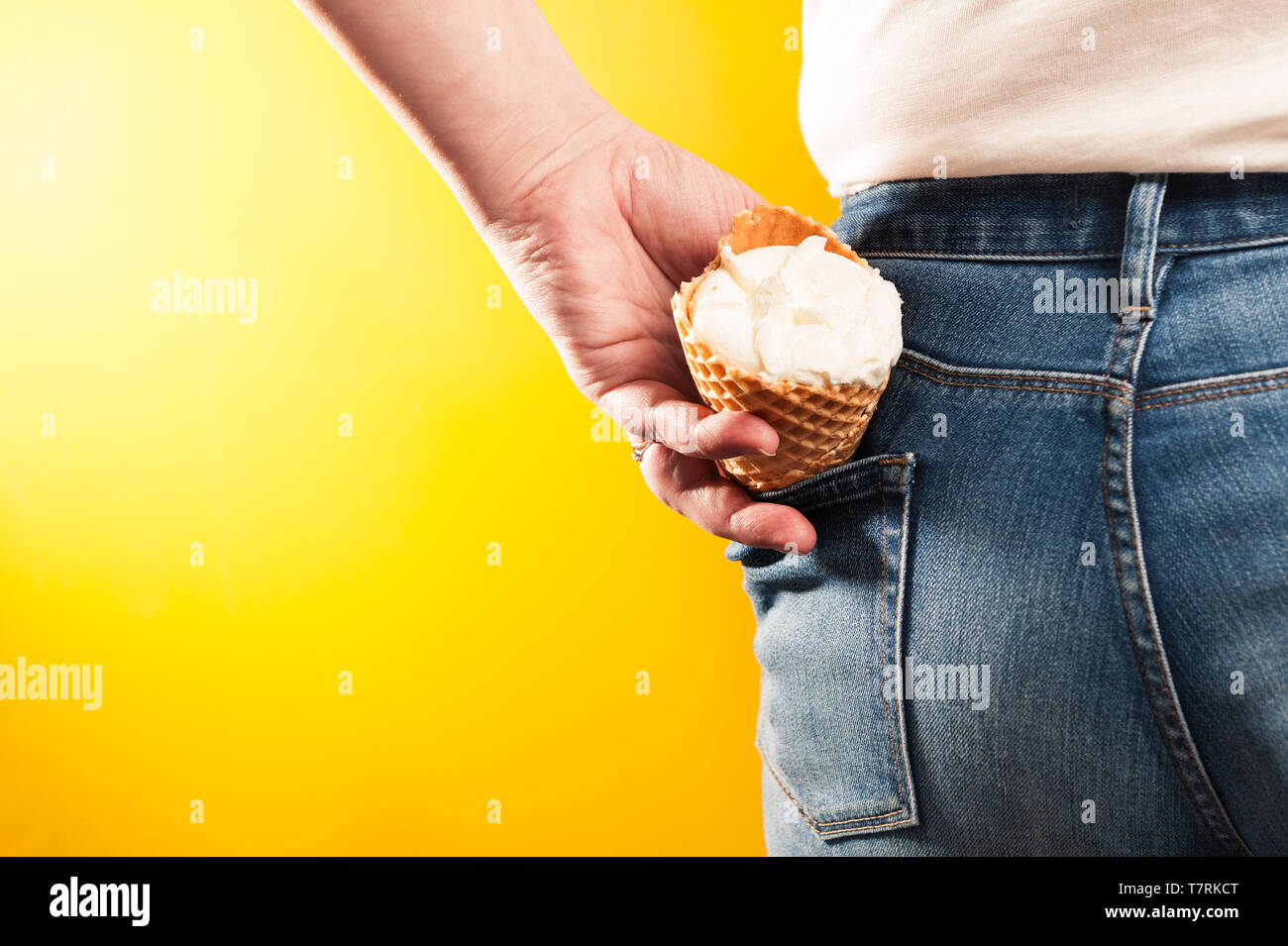 ice cream cone in jeans pocket on yellow background Stock Photo - Alamy
