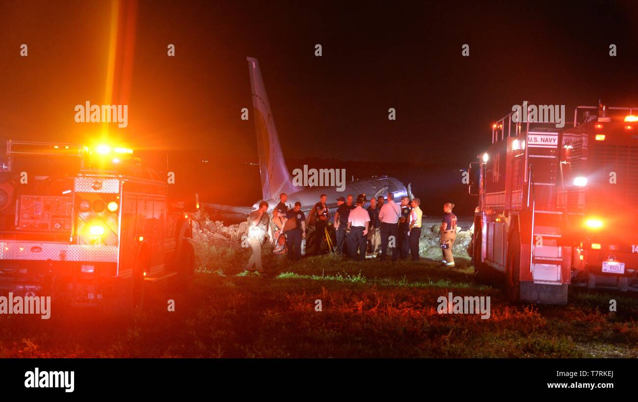 Emergency service personnel respond after a Boeing 737 aircraft skidded off the runway into the St. Johns River at Naval Air Station Jacksonville May 3, 2019 in Jacksonville, Florida. The charter aircraft was transporting 143 military passengers from Naval Station Guantanamo Bay, Cuba to Jacksonville. All passengers survived the crash. Stock Photo