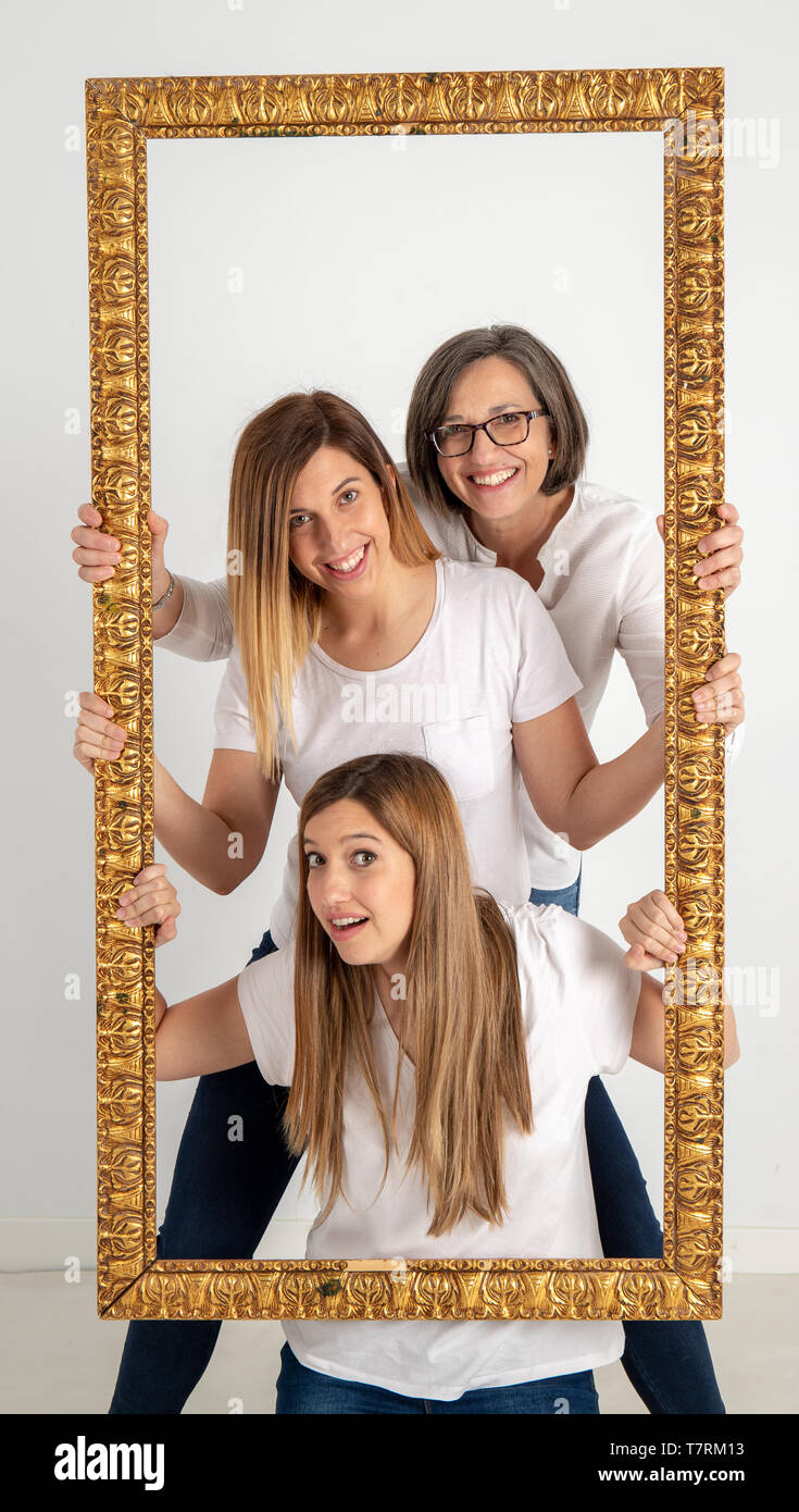 Family composed by mother and two twin sisters pose inside a pictorial ...