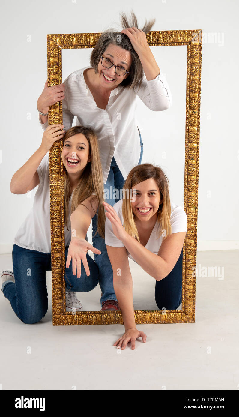 Family composed by mother and two twin sisters pose inside a pictorial ...