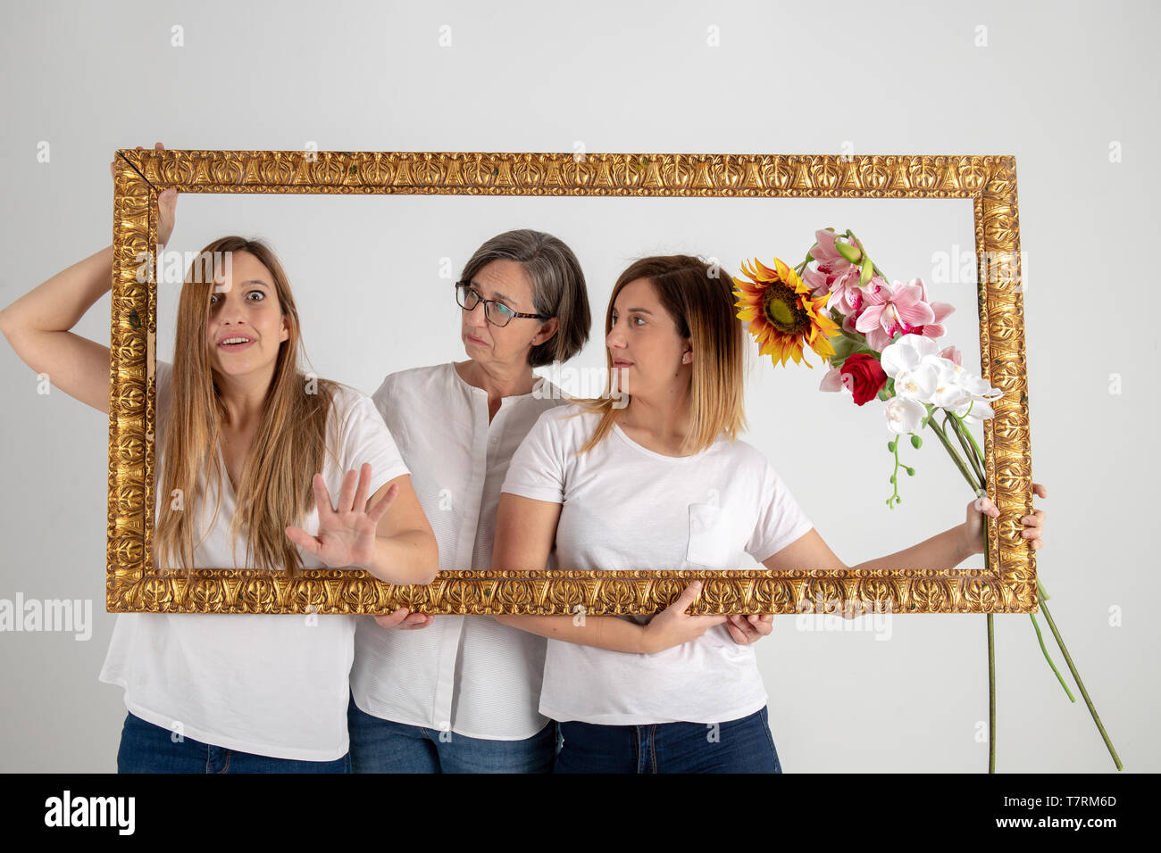 Family composed by mother and two twin sisters pose inside a pictorial ...