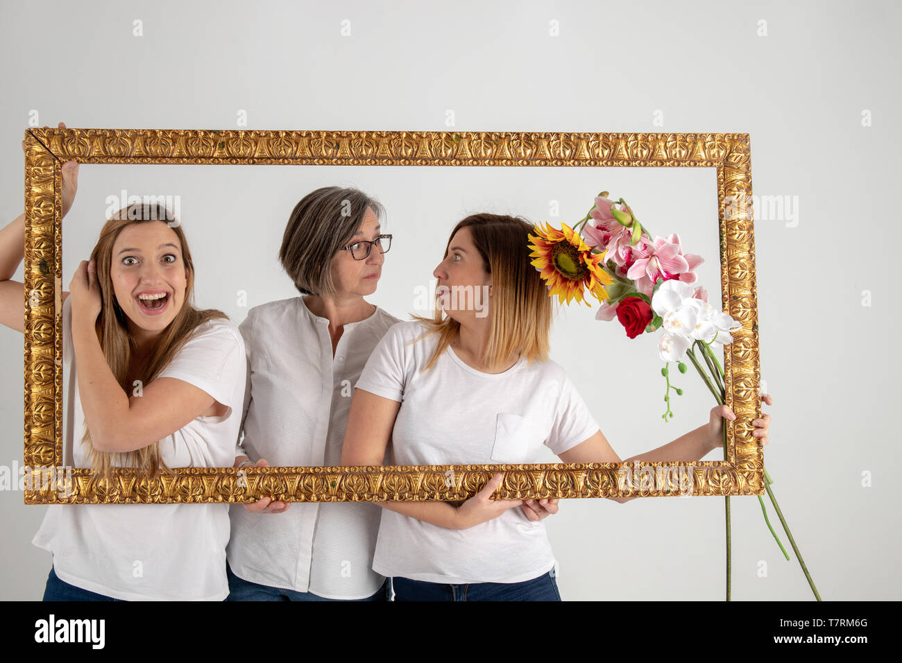 Family composed by mother and two twin sisters pose inside a pictorial ...