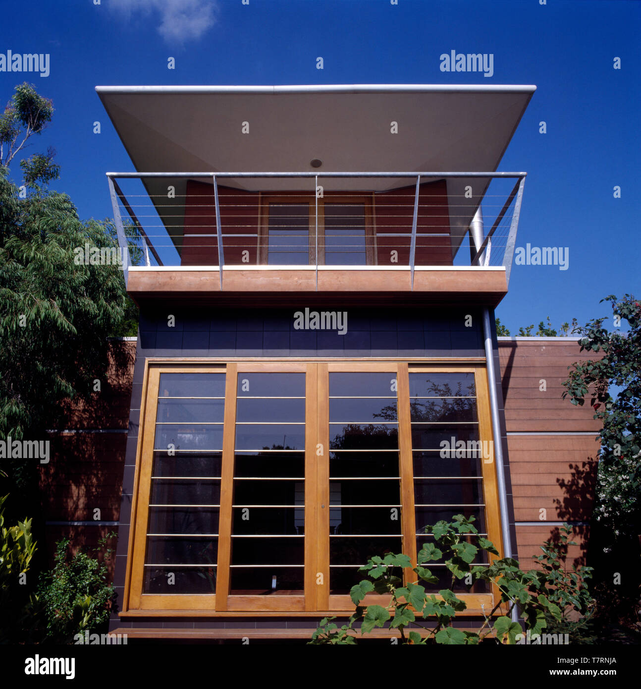 Exterior of a modern architectural house with a balcony below an