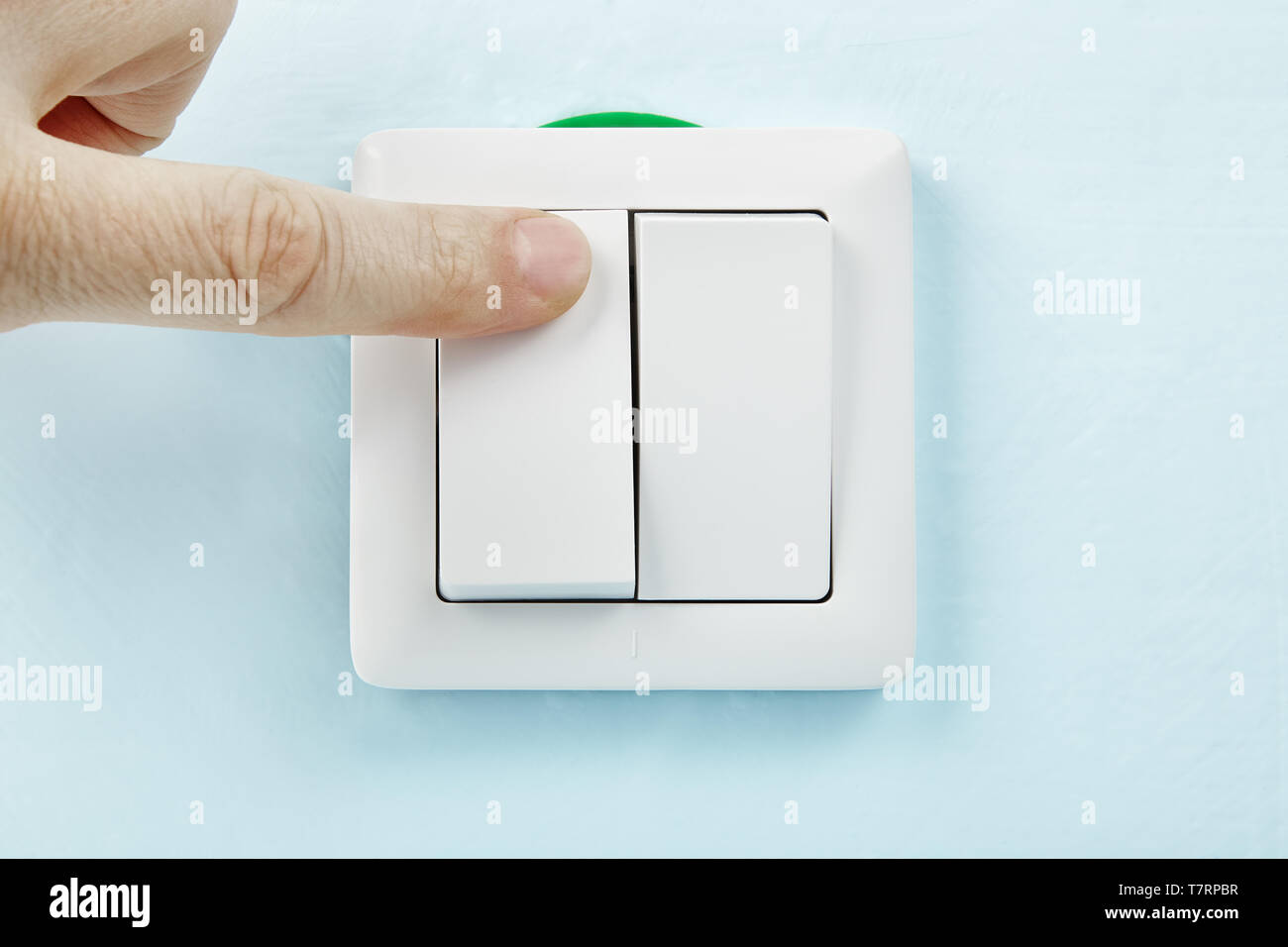 Worker is turning on or off new european standard light switch