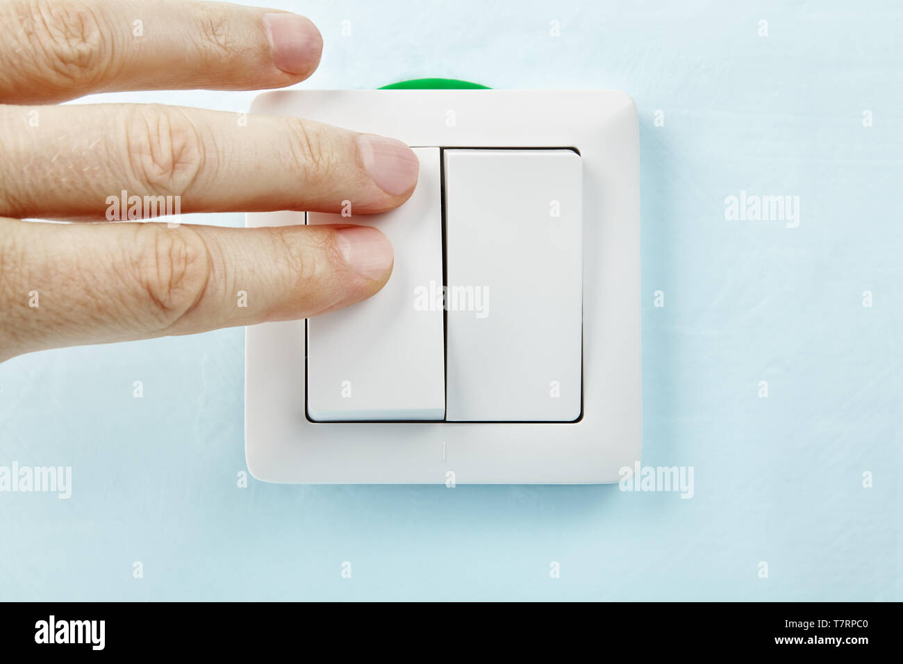 Electrician is pressing the button of new european standard light