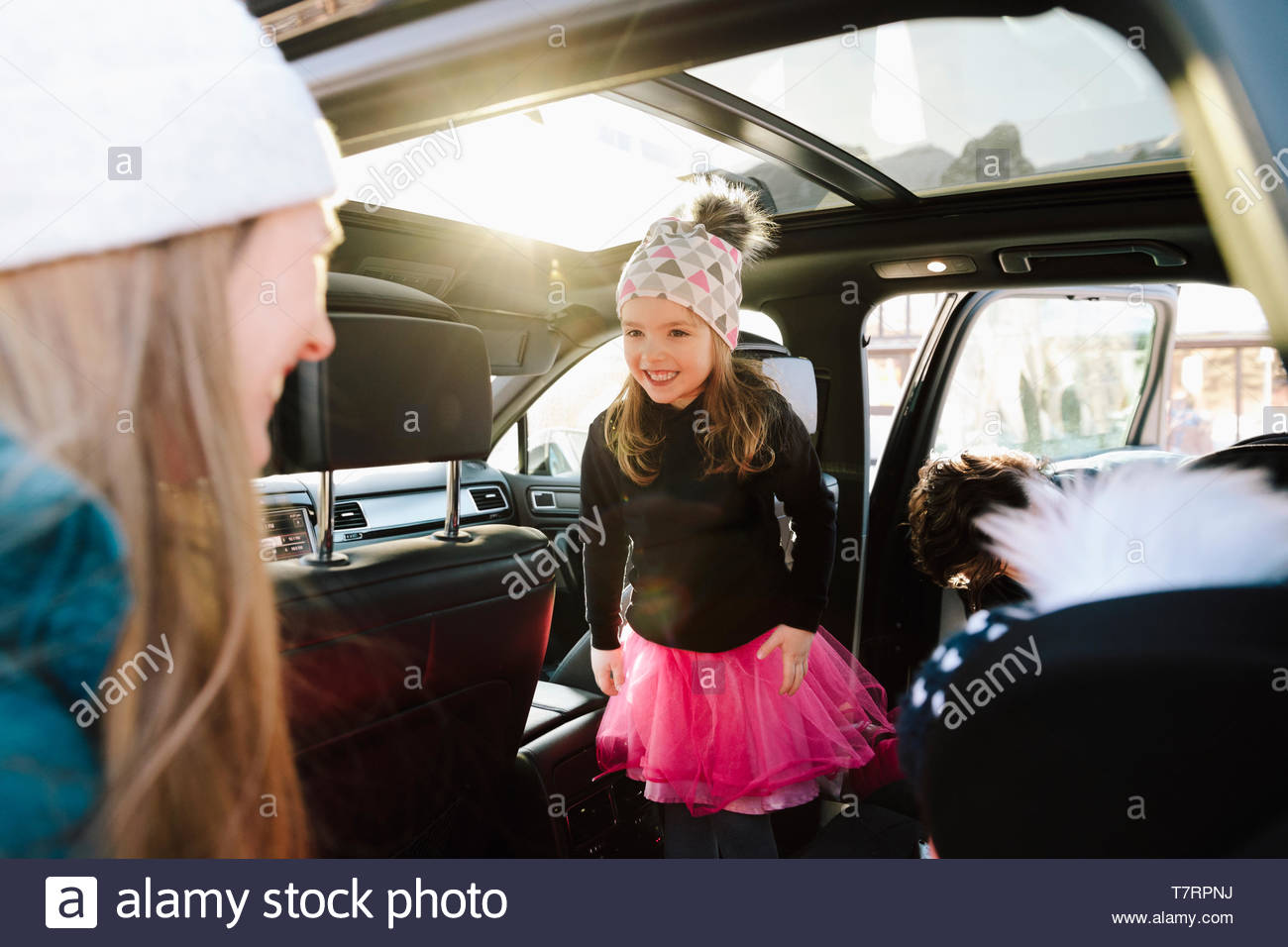 Cute toddler girl in car smiling at mother Stock Photo
