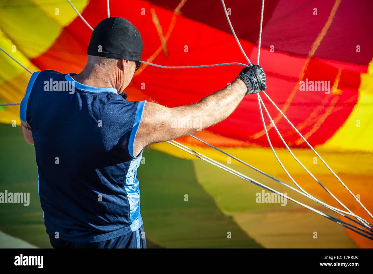 Crew member handling hot air balloon's ropes, White Sands Balloon