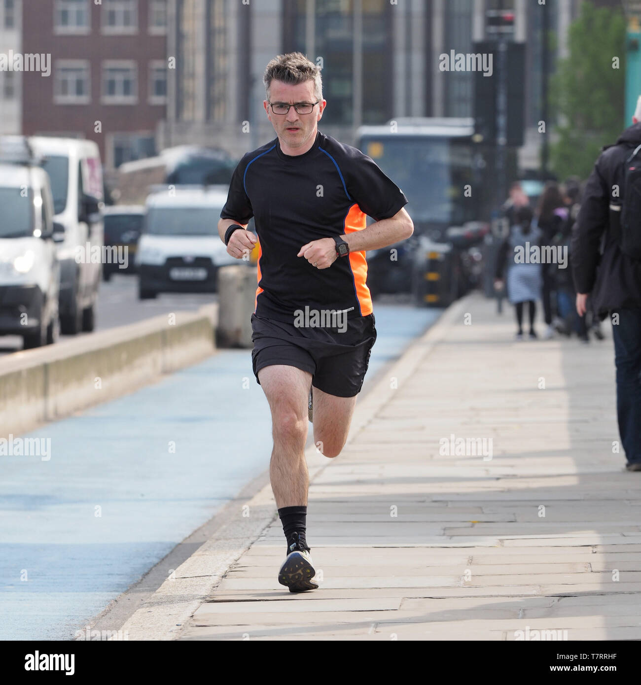 Jogger running on pavement, London, England, UK Stock Photo Alamy