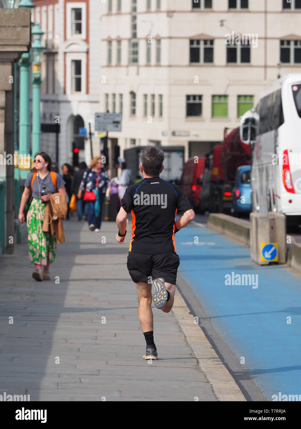 Jogger running on pavement, London, England, UK Stock Photo Alamy