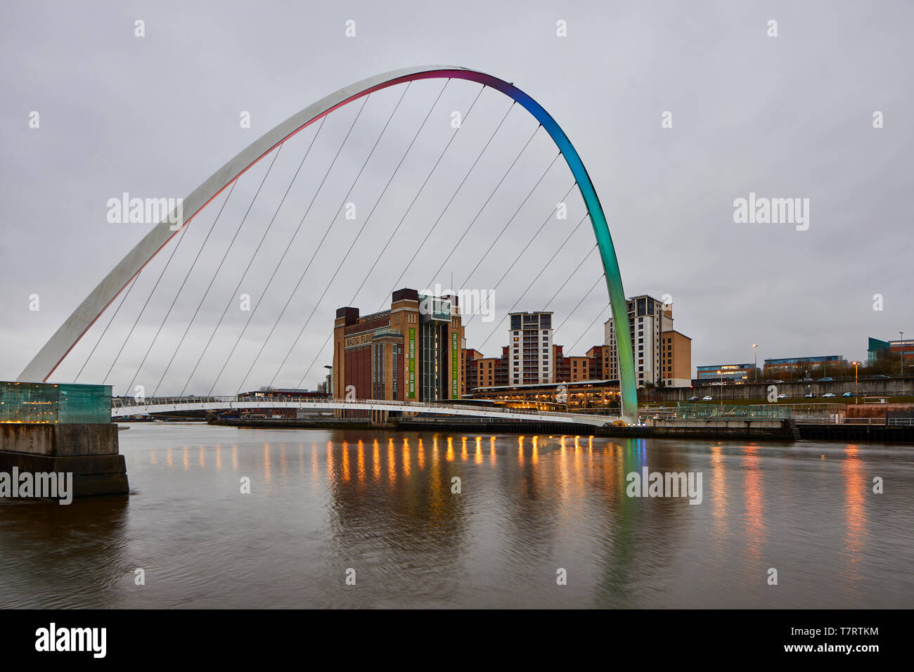 Iconic Newcastle upon Tyne  Quayside waterfront  landmark Millennium Bridge crossing the river Tyne and converted mill warehouse Baltic Centre for Con Stock Photo