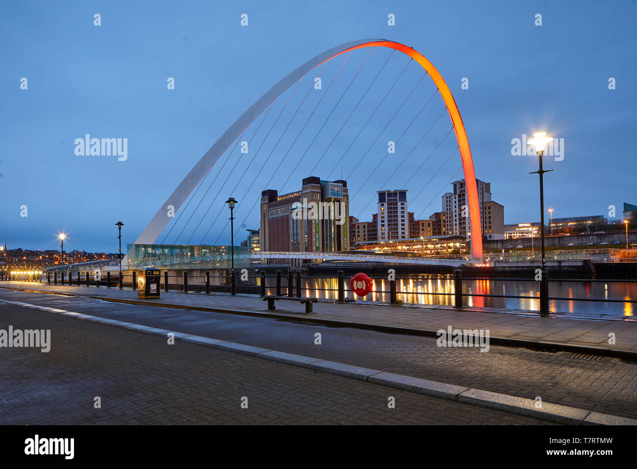 Iconic Newcastle upon Tyne  Quayside waterfront  landmark Millennium Bridge crossing the river Tyne and converted mill warehouse Baltic Centre for Con Stock Photo