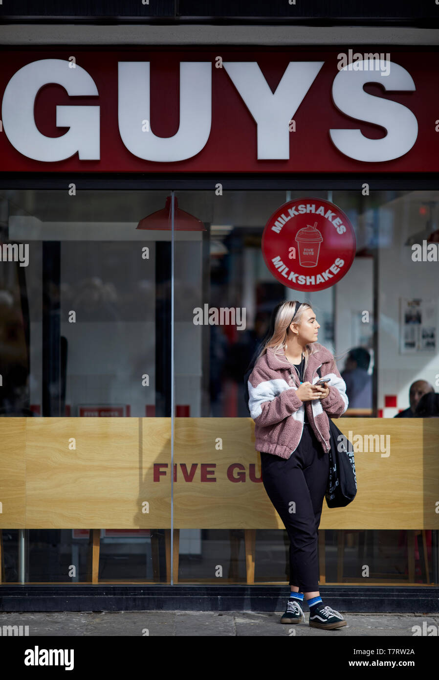 Newcastle upon Tyne, Five guys in the city centre Northumberland St Stock Photo