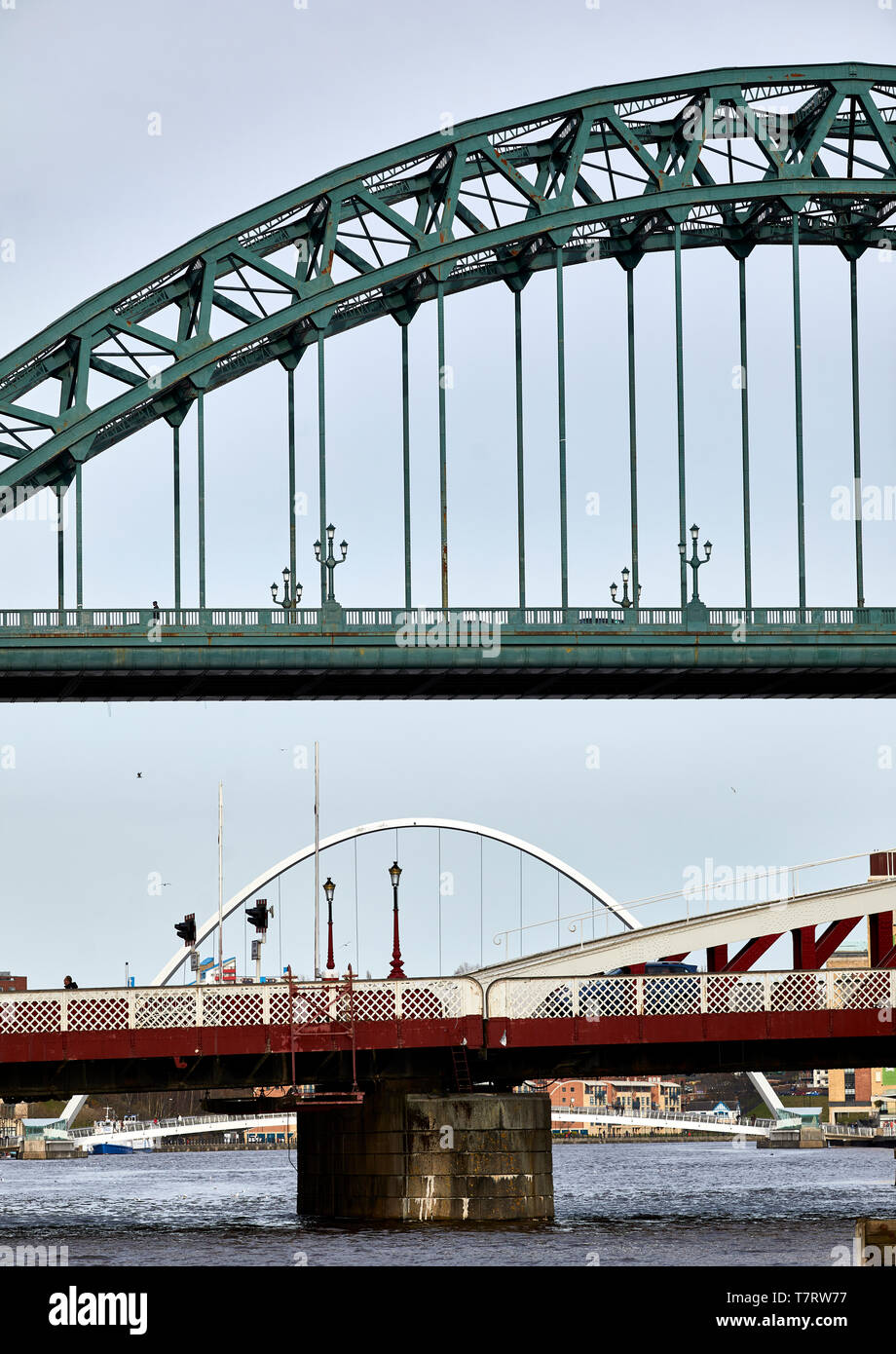 Iconic Newcastle upon Tyne  Quayside waterfront  landmark Tyne Bridge crossing the river Tyne and Sage Gateshead looking to the Tyne Bridge Stock Photo
