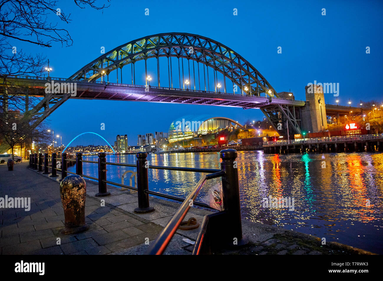 Iconic Newcastle upon Tyne  Quayside waterfront  landmark Tyne Bridge crossing the river Tyne and Sage Gateshead looking to the Tyne Bridge Stock Photo