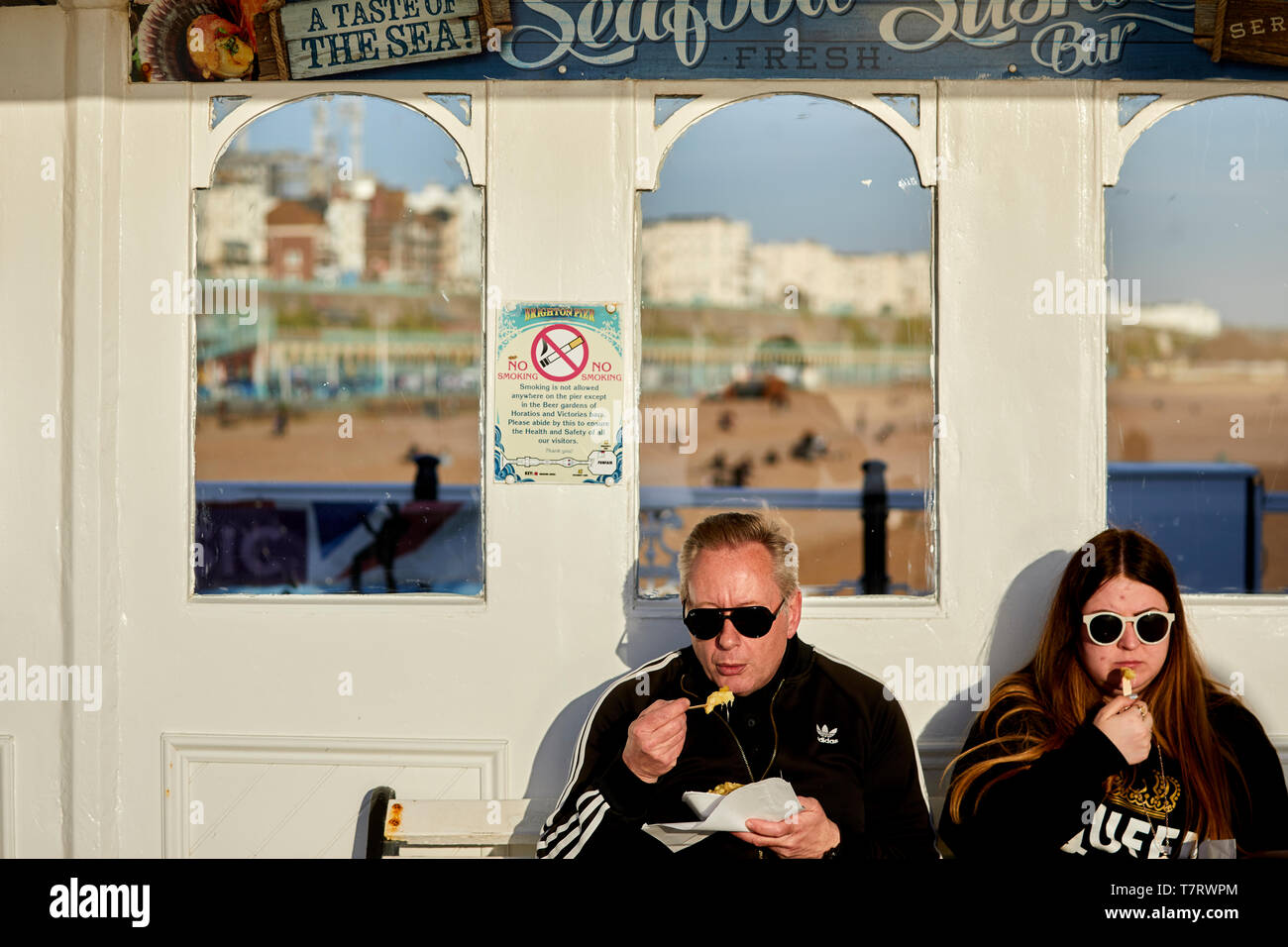 Tourist enjoying fish and chips on Brighton Pier Stock Photo Alamy