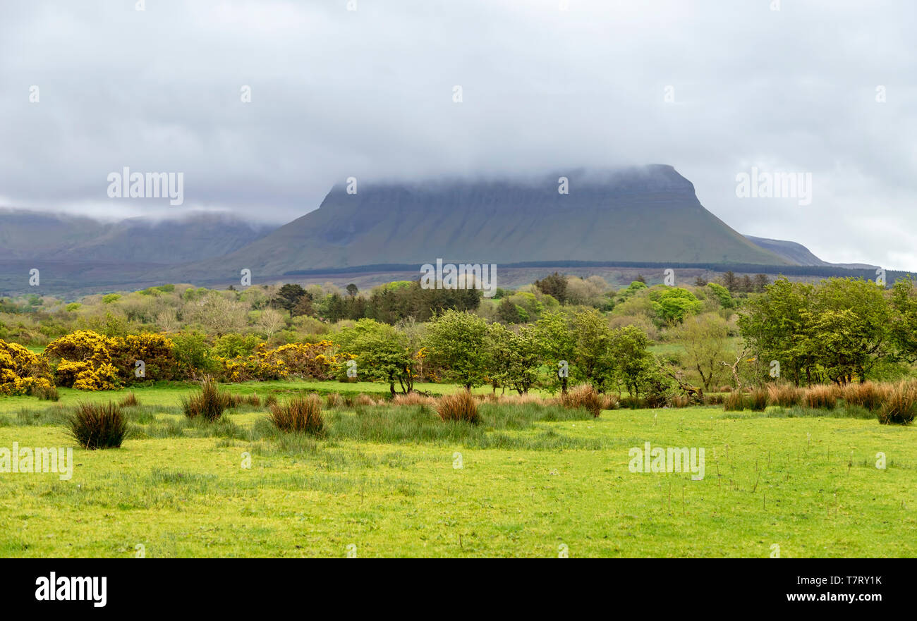 Benbulbin, or Benbulben, a large flat-topped rock formation  veiled by low hanging clouds, Mullaghmore Peninsula, County Sligo, Republic of Ireland. Stock Photo
