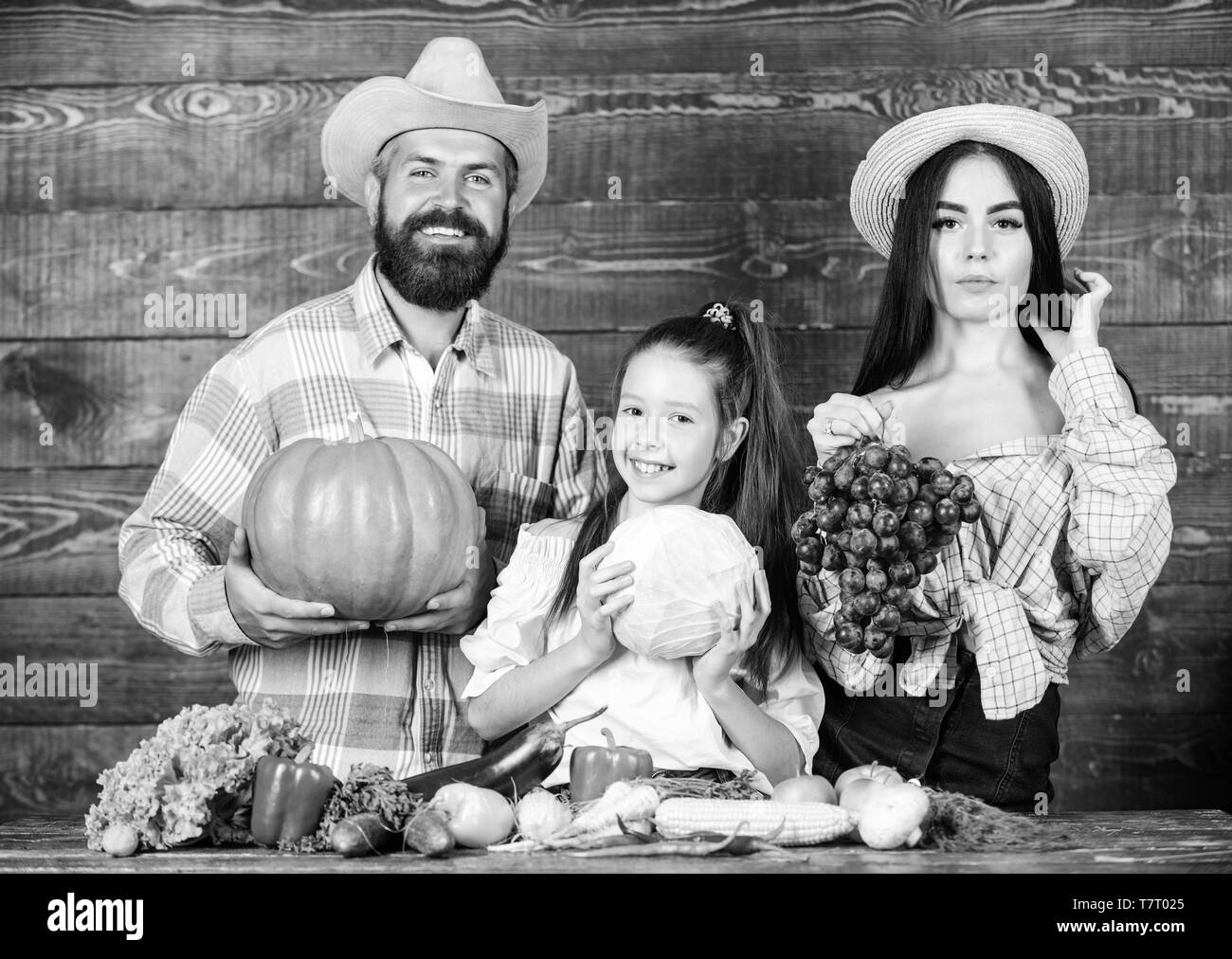 Parents and daughter celebrate autumn harvest festival. Family farm