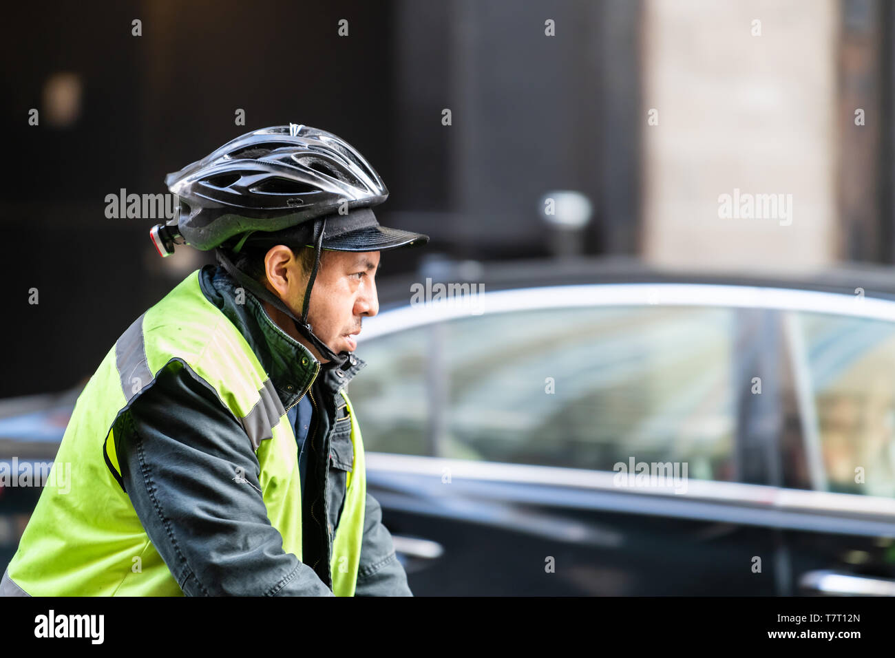 New York City - April 6, 2018: People man on bicycle bike with helmet and vest in NYC midtown Stock Photo