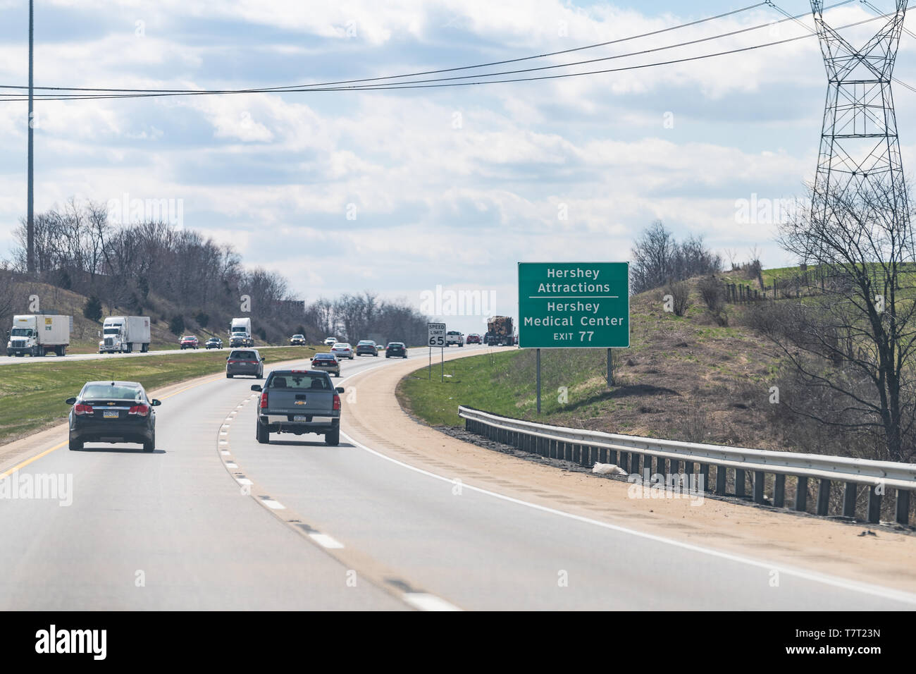 East Hanover Township, USA - April 8, 2018: Green road sign to Hershey Attractions, Medical Center city, town in Pennsylvania on interstate highway 81 Stock Photo