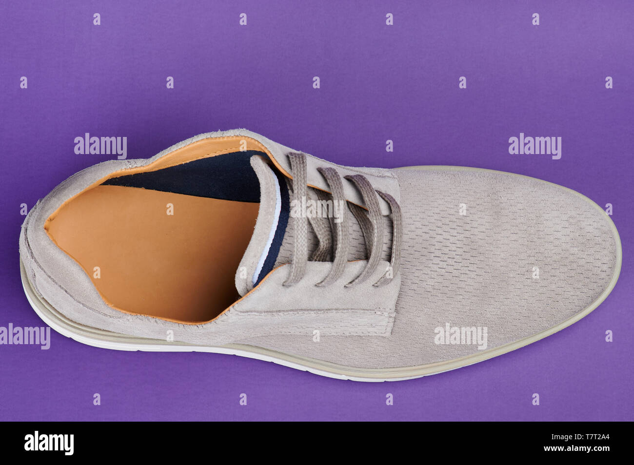 One man gray shoe above top view on purple background Stock Photo