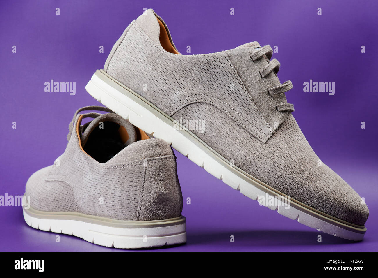 Elegant gray pair of shoes different views isolated on purple background Stock Photo