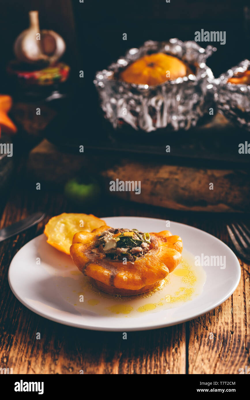 Yellow pattypan squash stuffed with minced meat on white plate Stock Photo