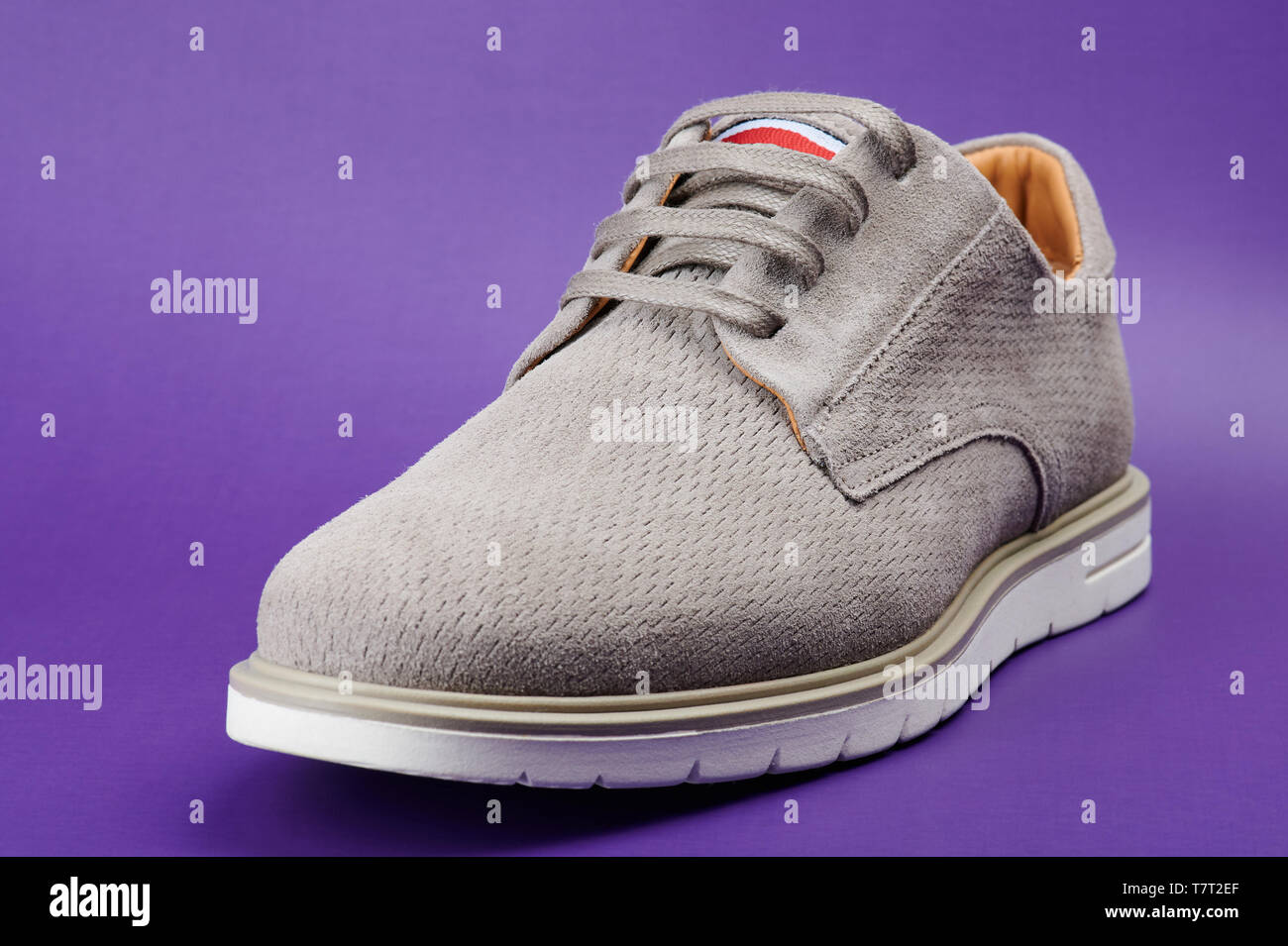 Closeup of gray man shoe isolated on purple background Stock Photo