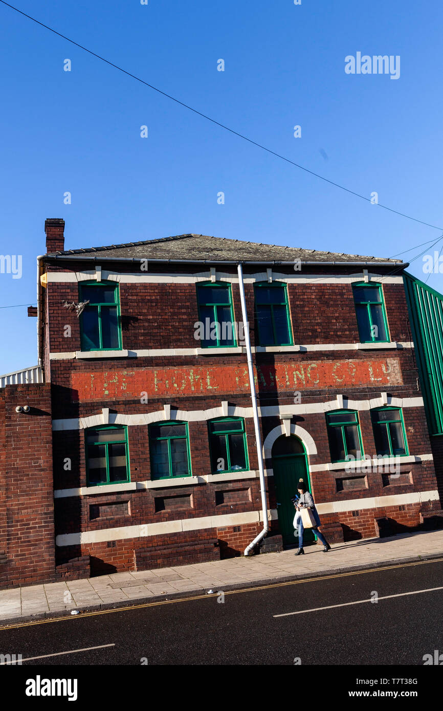 Passing by the green door of an old building in Rotherham, Yorkshire. Stock Photo