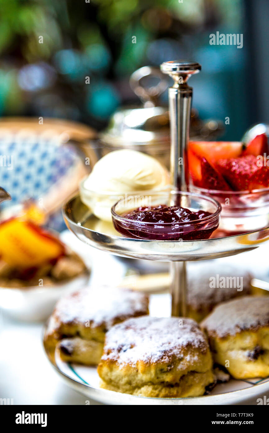 Scones, jam and clotted cream on a tiered tray, afternoon tea at Ivy in the Park in Canary Wharf, London, UK Stock Photo
