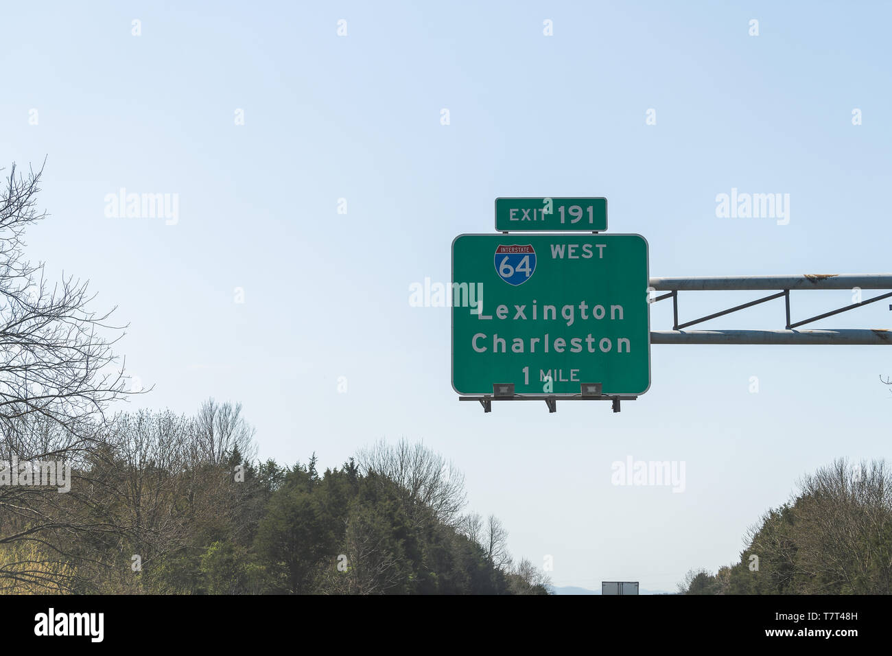 Road sign above highway road of Interstate 64 West with direction to exit 191 in 1 mile to Lexington and Charleston in Virginia Stock Photo