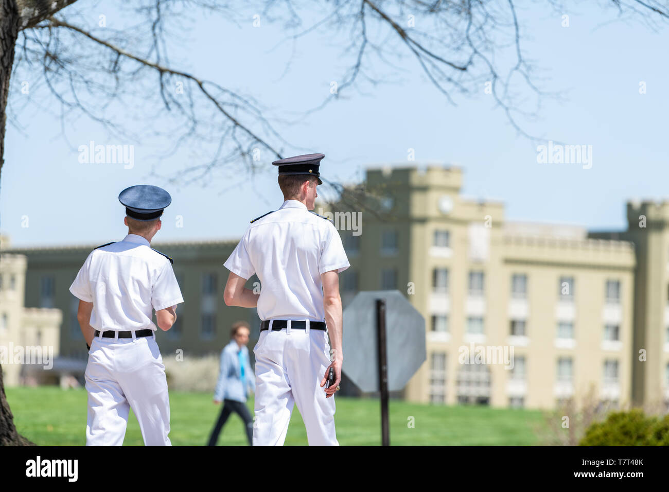 Lexington, USA - April 18, 2018: Men male cadets students in white uniforms walking at Virginia Military Institute main campus grounds near Clayton Ha Stock Photo