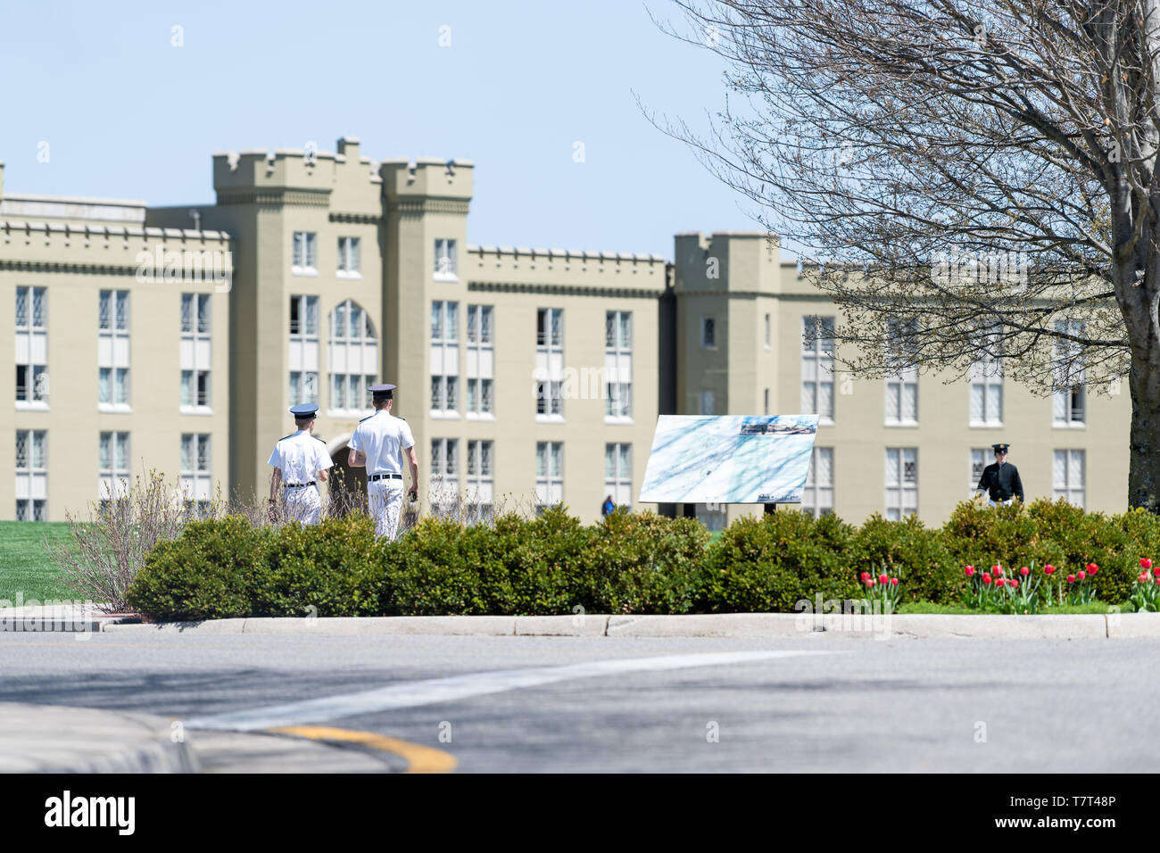 Lexington, USA - April 18, 2018: Men, male cadets students in white uniforms walking at Virginia Military Institute main campus grounds in front of Cl Stock Photo