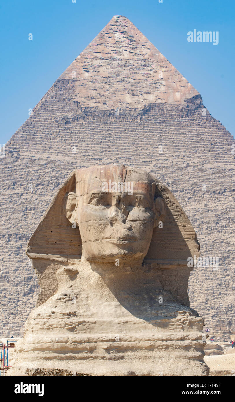 Pyramid of Pharaoh Khafra rises behind the Great Sphinx, in Giza, Egypt. Both are believed to have been created around 2500 BCE. Stock Photo
