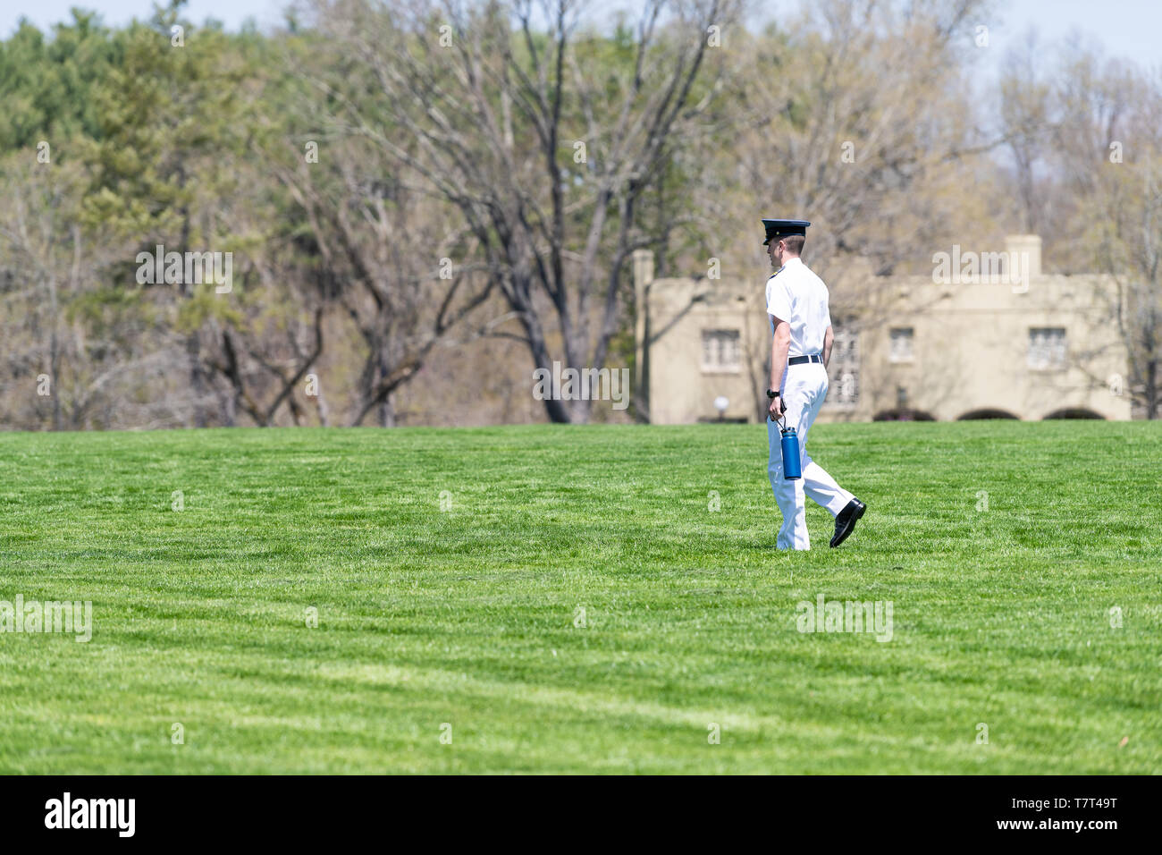Lexington, USA - April 18, 2018: Young cadet officer walking in white uniform on campus grounds green grass of Virginia Military Institute in city at  Stock Photo