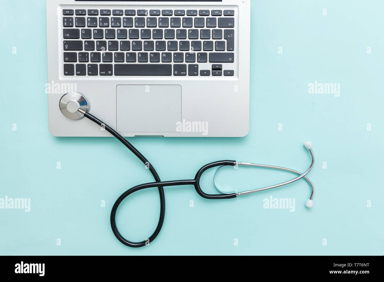 Stethoscope keyboard laptop computer isolated on blue background ...