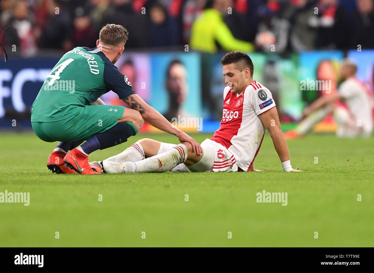Amsterdam, Netherlands. 08th May, 2019. Football, Champions League, knockout round, semi-final, return leg Ajax Amsterdam - Tottenham Hotspur, in the Johan Cruijff ArenA. Dusan Tadic of Ajax sits disappointed on the court after the defeat and is comforted by Toby Alderweireld of Tottenham. Credit: Marius Becker/dpa/Alamy Live News Stock Photo