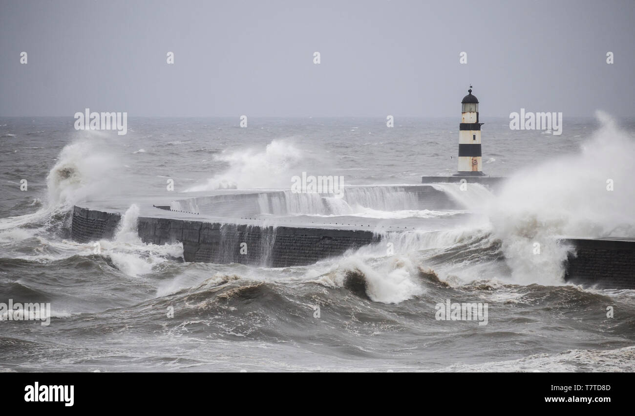 Seaham, County Durham, UK. 9th May 2019. UK Weather: Storm before  the calm. Huge waves batter the harbour wall and lighthouse at Seaham, as a stron northerly wind blows down the North sea. The weather across the UK is forecast to warm up over the weekend. Credit: Alan Dawson/Alamy Live News Stock Photo