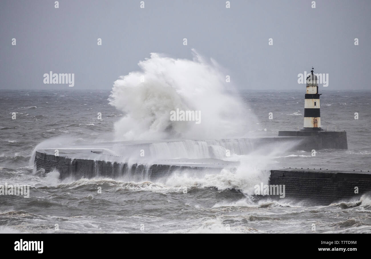 Seaham, County Durham, UK. 9th May 2019. UK Weather: Storm before  the calm. Huge waves batter the harbour wall and lighthouse at Seaham, as a stron northerly wind blows down the North sea. The weather across the UK is forecast to warm up over the weekend. Credit: Alan Dawson/Alamy Live News Stock Photo