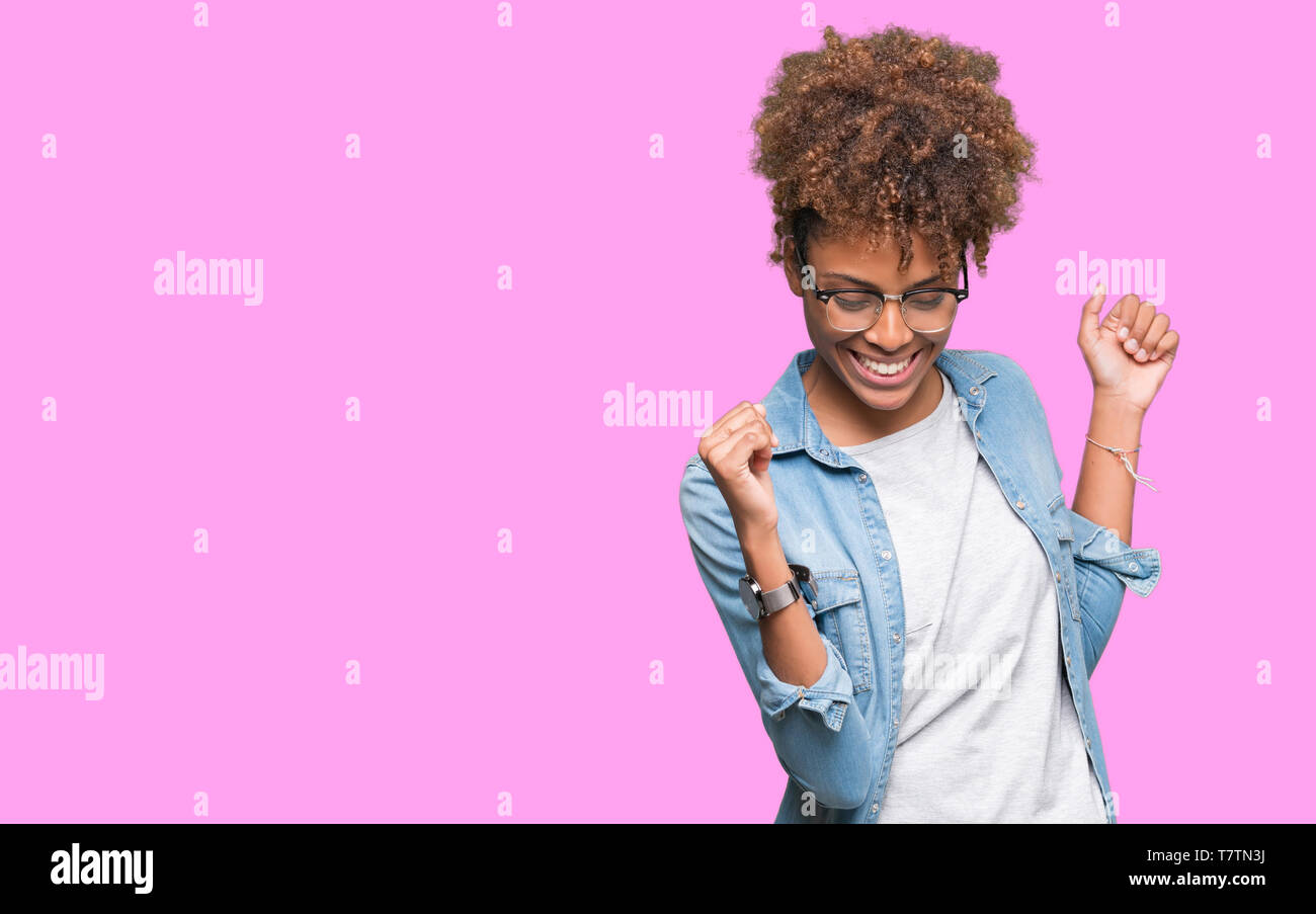 https://c8.alamy.com/comp/T7TN3J/beautiful-young-african-american-woman-wearing-glasses-over-isolated-background-dancing-happy-and-cheerful-smiling-moving-casual-and-confident-listen-T7TN3J.jpg