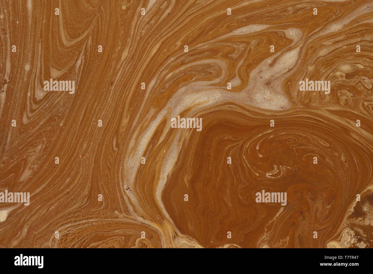 Abstract drawings drawn in a puddle of mud, an ideal image to use as a neutral background. Stock Photo