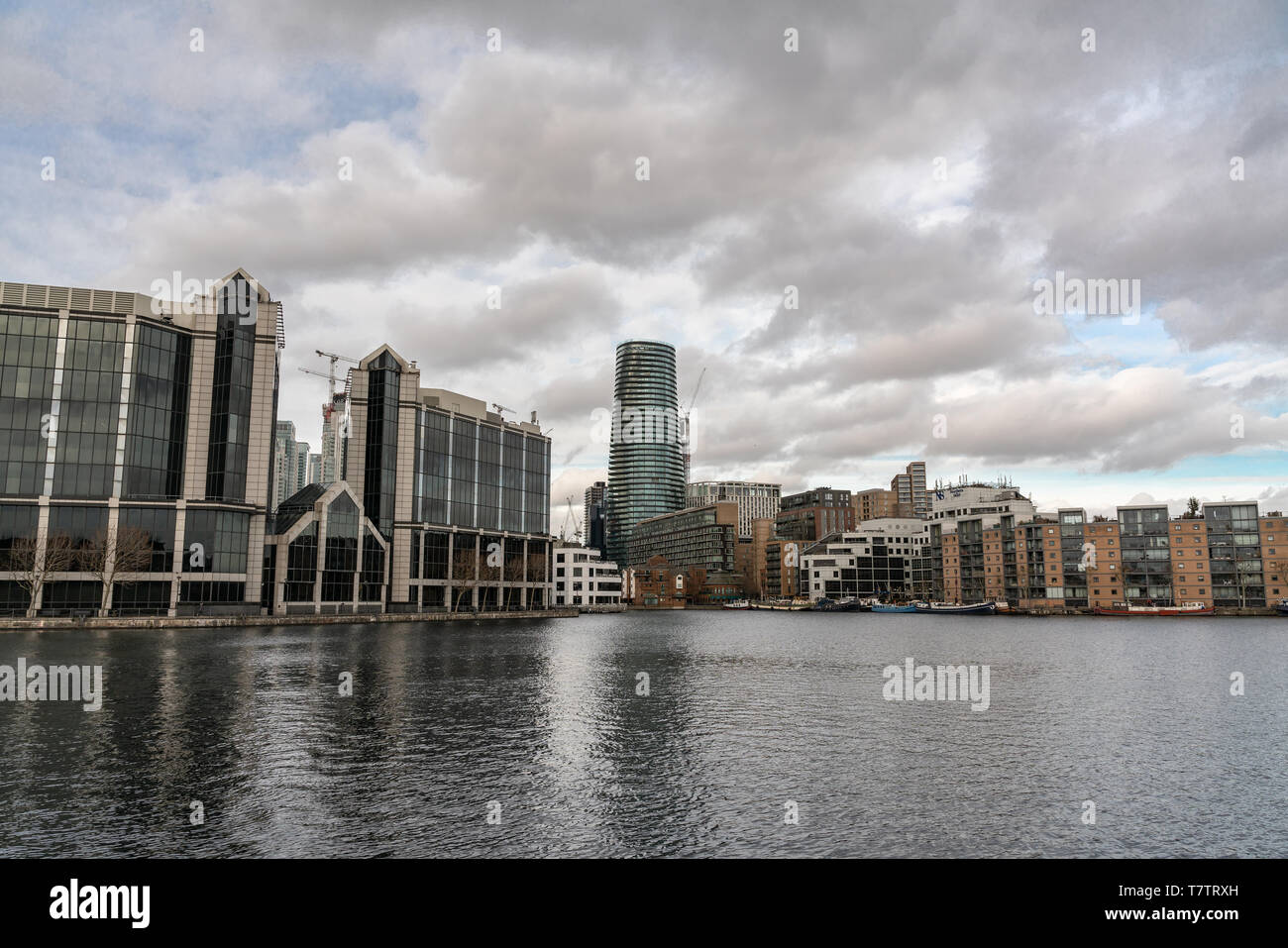 London, UK - March 05, 2019: Flats and houses along the banks of Canary Wharf, oversee river side apartments. Stock Photo